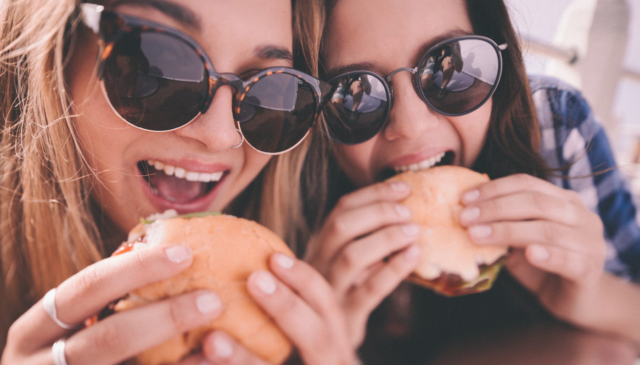 Girl best friends enjoying burgers