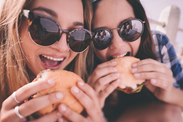 Girl best friends enjoying burgers